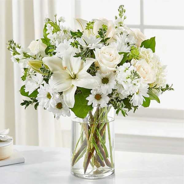 White flowers arranged in a clear glass vase