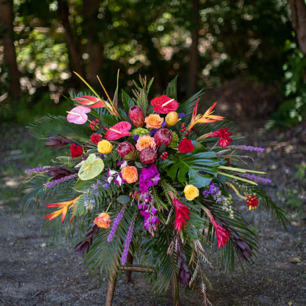 Tropical floral arrangement with red, pink, orange, and purple blooms