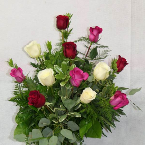 Mixed roses in red, pink, and white in a glass vase