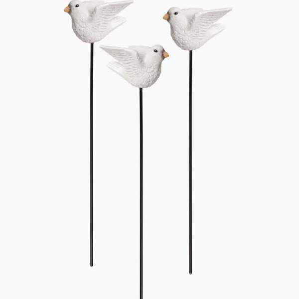 Three white bird garden stakes with long black rods