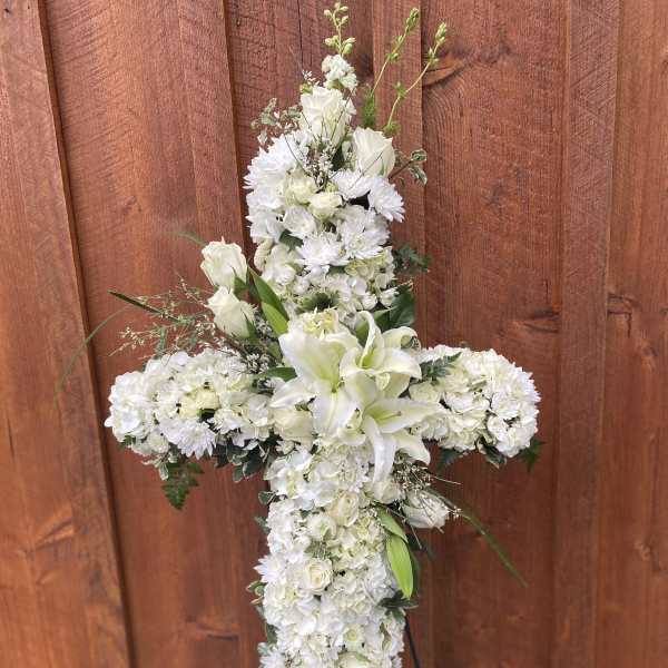 White floral cross arrangement with lilies and chrysanthemums