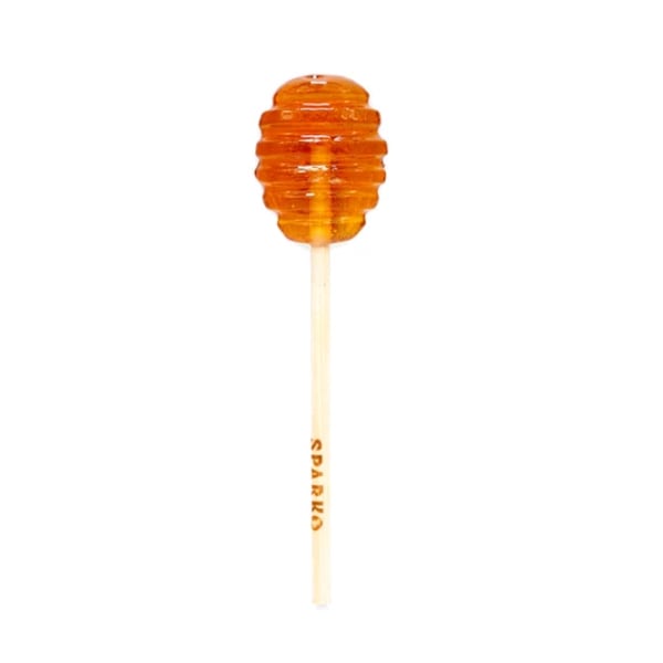 Orange honey dipper lollipop on a stick