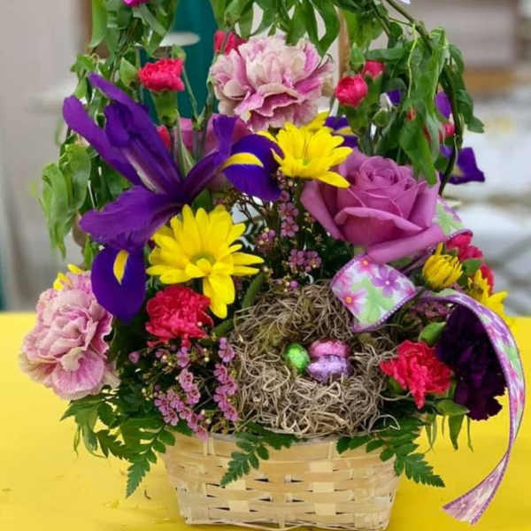 Colorful flower basket with butterflies and a bird nest centerpiece