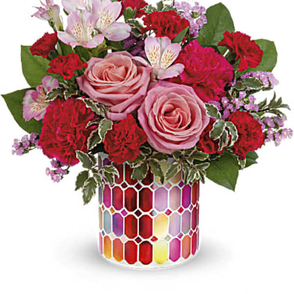 Bouquet of pink roses and red carnations in a colorful mosaic vase