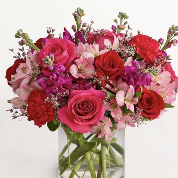 Pink and red rose bouquet in a clear glass vase