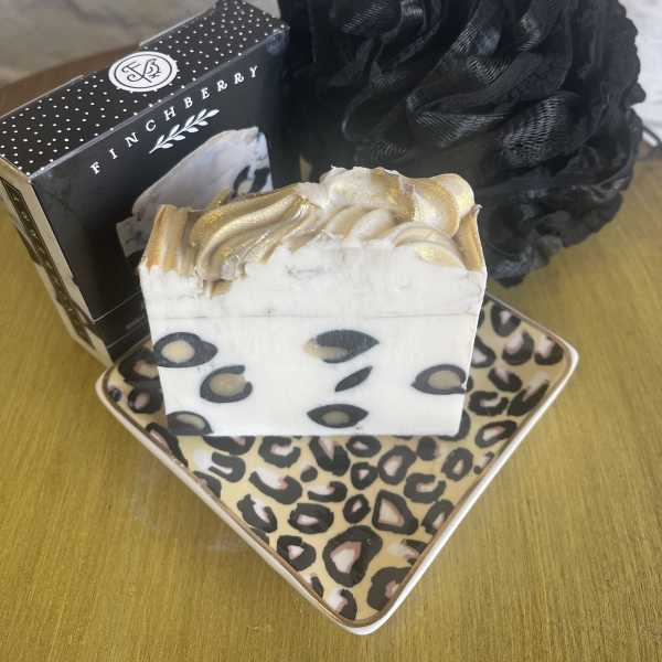 Soap bars and a black decorative flower on patterned trays