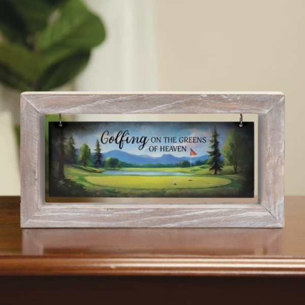 Framed memorial sign with a golf course scene and the words "Golfing on the Greens of Heaven"