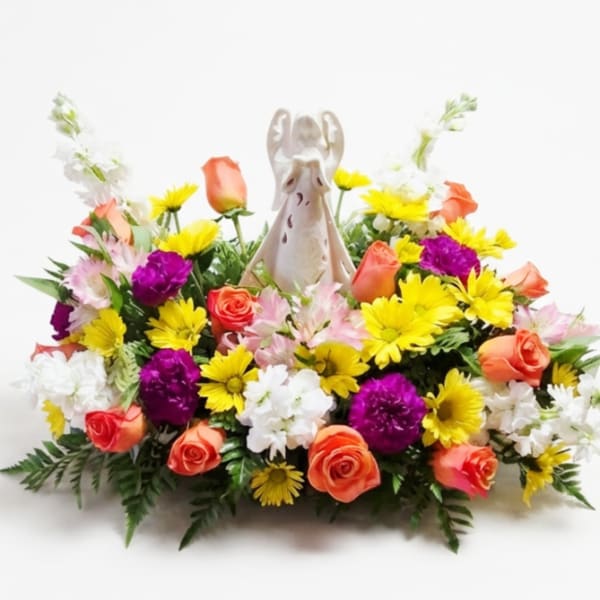Colorful floral arrangement with an angel figurine in the center