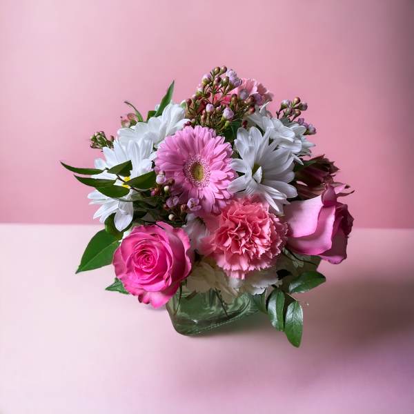 Pink and white mixed flower bouquet in a glass vase