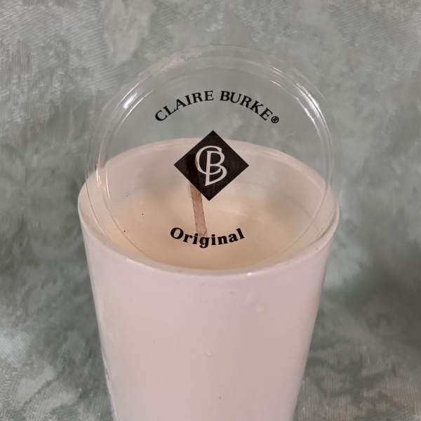 Pink candle in a clear plastic cup with a lid