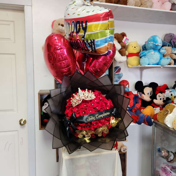 Red rose bouquet with a crown topper and birthday balloons