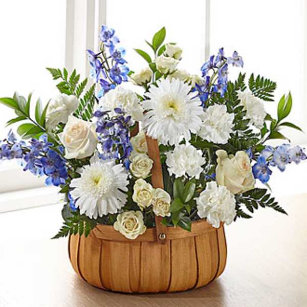 Basket arrangement of white and blue flowers
