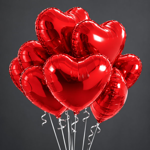 Cluster of red heart-shaped balloons with curling ribbons