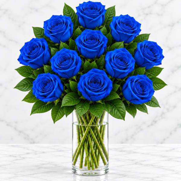 Bouquet of vivid blue roses in a clear glass vase