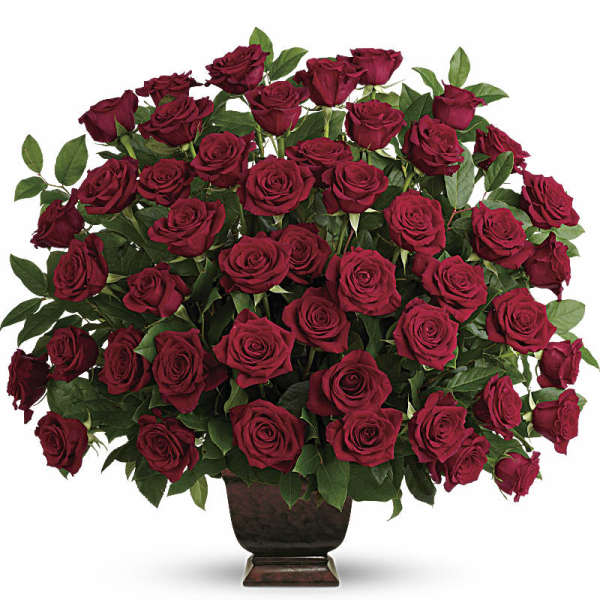 Large bouquet of red roses in a dark vase