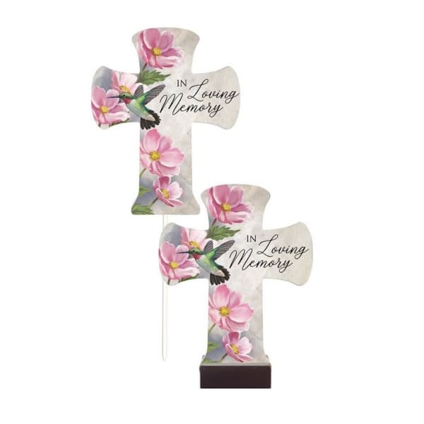 Two cross-shaped memorial plaques with pink flowers and hummingbirds