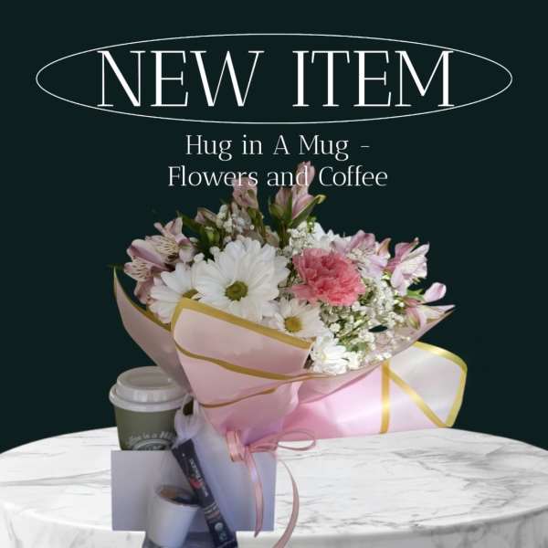 Bouquet of pink and white flowers with a coffee cup and gift items