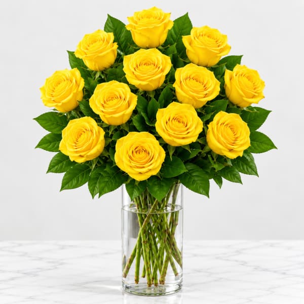 Yellow roses arranged in a clear glass vase