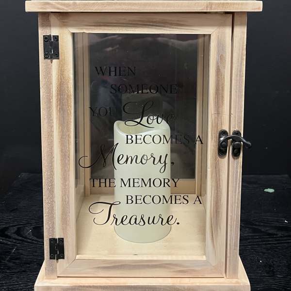 Wooden memorial lantern with a candle and sympathy quote