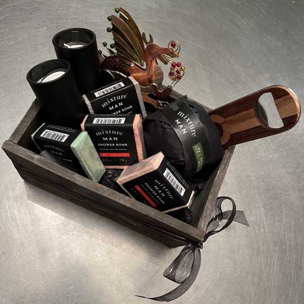 Gift basket with shower bombs, candles, and a metal dragon ornament