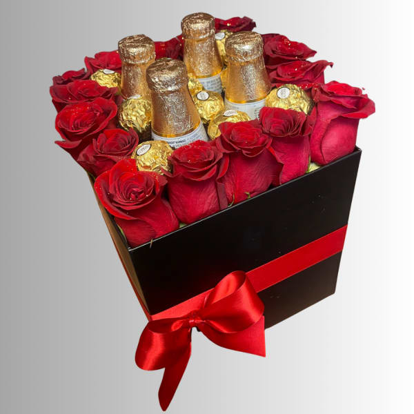 Red roses and gold-wrapped chocolates in a black gift box with a red ribbon