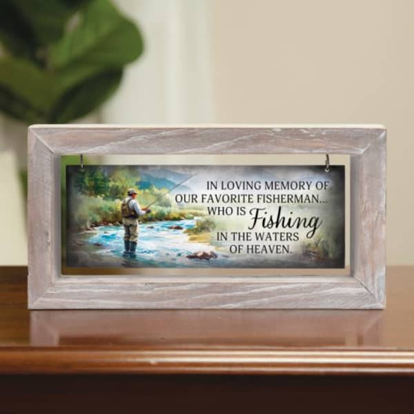 Framed memorial plaque with a fisherman scene and sympathy text