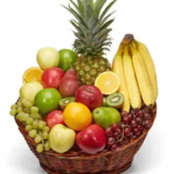 Basket of assorted fruit with a pineapple and bananas