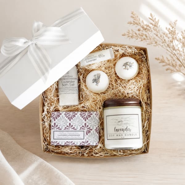 Lavender bath gift set in a box with soap, bath salt, candles, and a ribbon