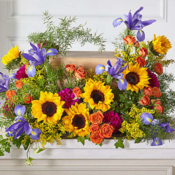 Bright mixed bouquet with sunflowers, purple irises, and orange roses