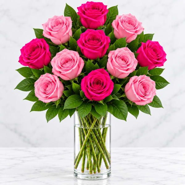 Bouquet of pink and hot pink roses in a clear glass vase