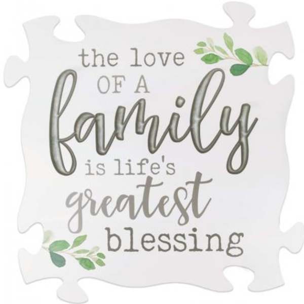 Decorative puzzle-piece sign with the words "the love of a family is life's greatest blessing"
