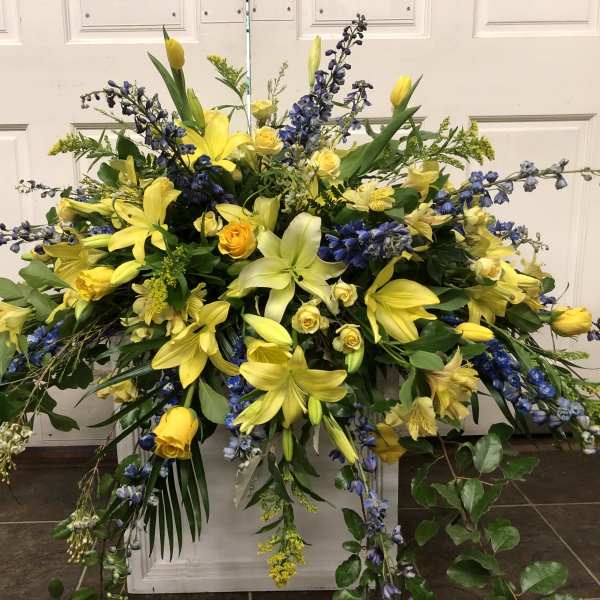 Large yellow and blue floral spray with lilies and roses