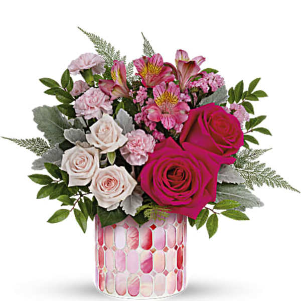 Pink and white rose bouquet in a patterned glass vase