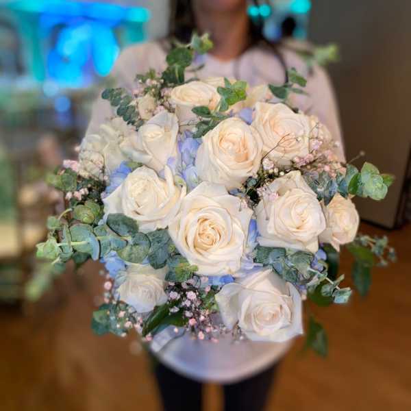 Bouquet of white roses with blue accents and eucalyptus