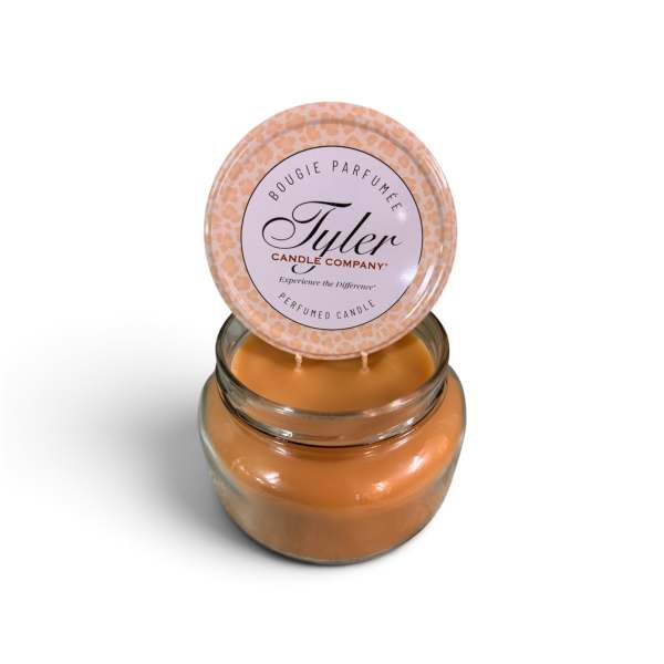 Orange scented candle in a glass jar with a printed lid