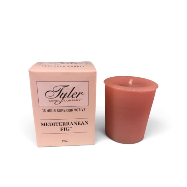Pink boxed votive candle beside a coral candle