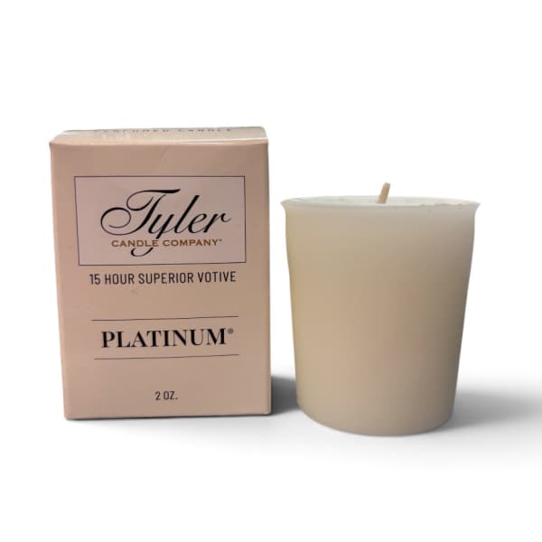 Beige votive candle beside its matching box