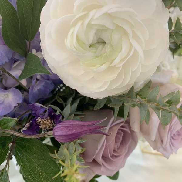 Bouquet with white and lavender flowers and green foliage