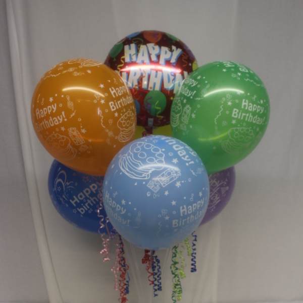 Cluster of colorful birthday balloons on a clear stand