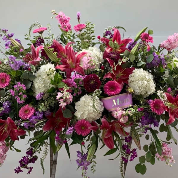 Large pink, purple, and white floral spray with lilies and hydrangeas