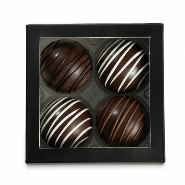 Box of four chocolate truffles with striped drizzle