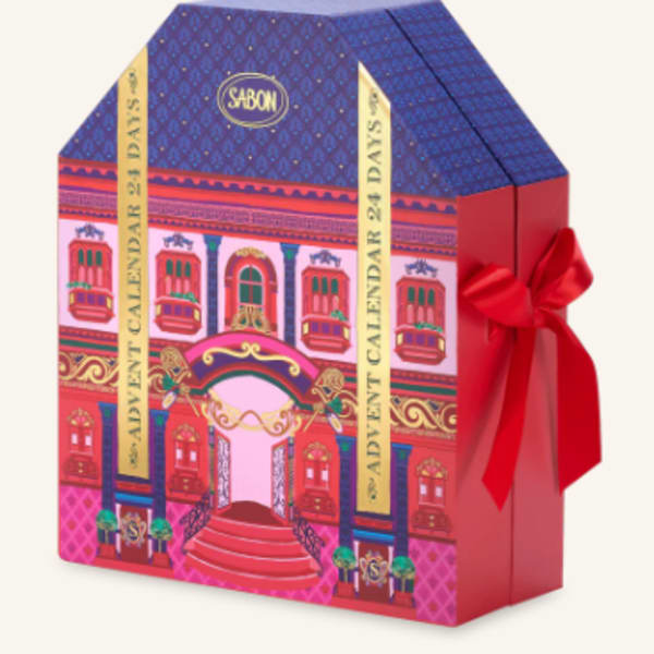 Decorative gift box with a red ribbon and colorful building illustration