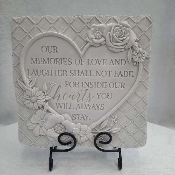 Decorative memorial plaque with raised flowers and a heart-shaped quote