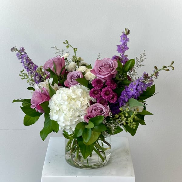 Pink and purple mixed bouquet in a clear glass vase