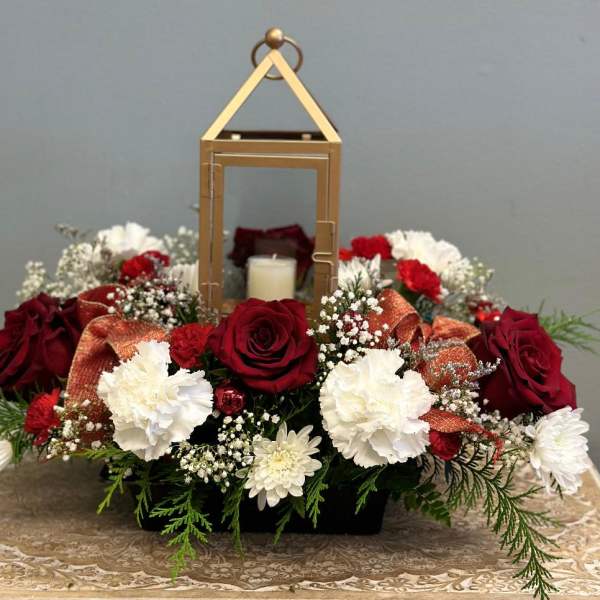 Red and white floral arrangement with a lantern centerpiece