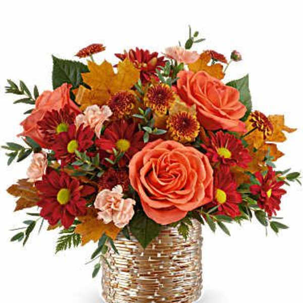 Orange roses and red daisies in a woven basket