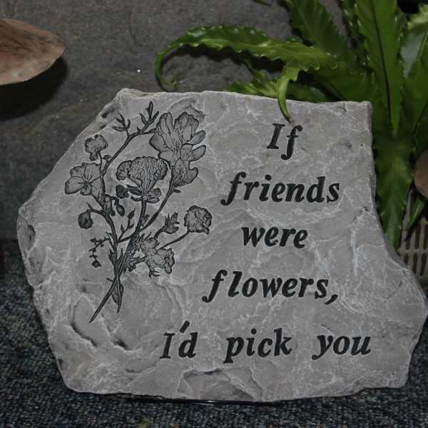 Engraved stone plaque with a flower illustration and friendship quote