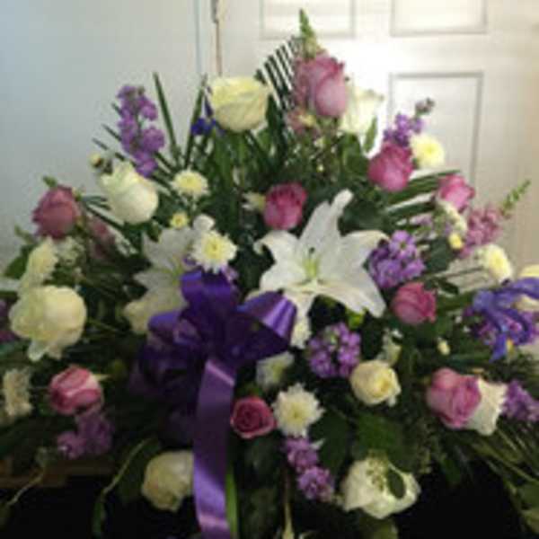 Large mixed bouquet with white lilies, roses, and purple flowers