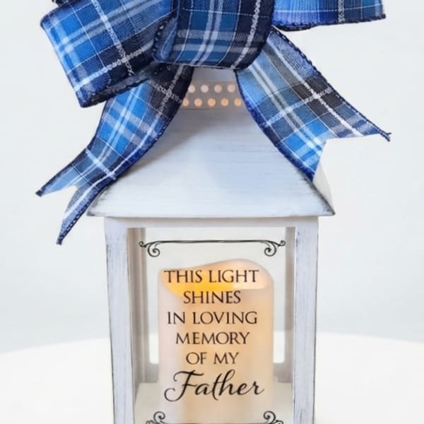 White memorial lantern with a blue plaid bow and a Father remembrance message