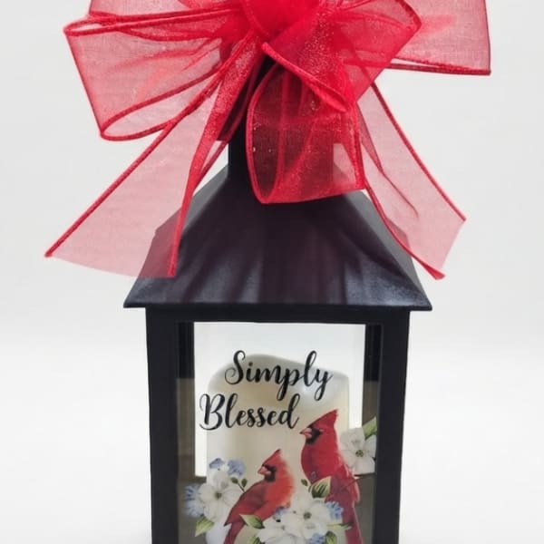 Black lantern with a red bow and a "Simply Blessed" card inside